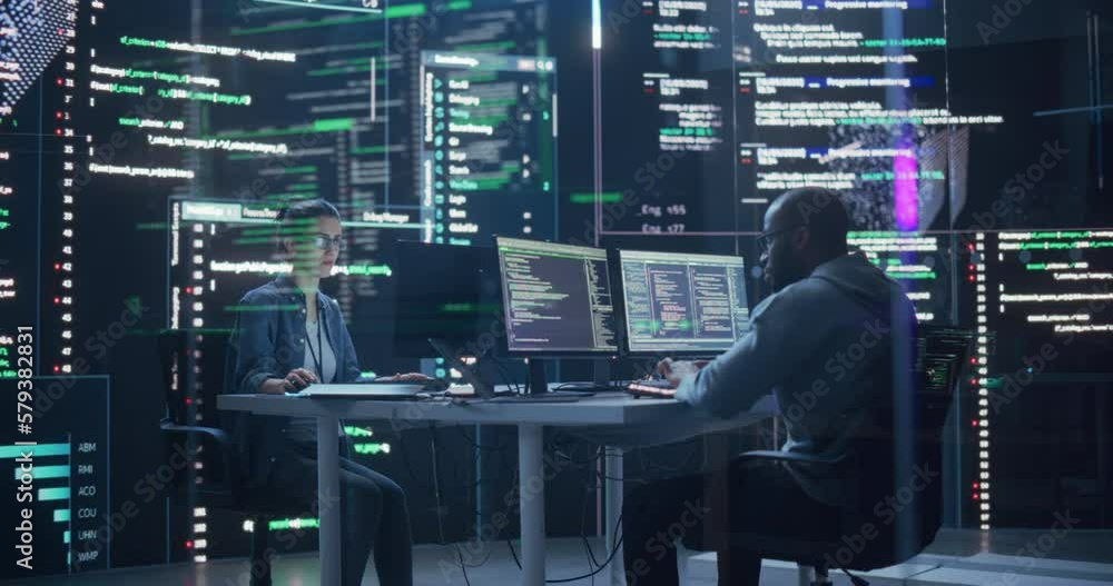 Fototapete Portrait of Two Colleagues Working in a Monitoring Room, Surrounded by Big Screens Displaying Lines of Programming Language Code. Professional Hackers Breaking Through Cybersecurity Protection System