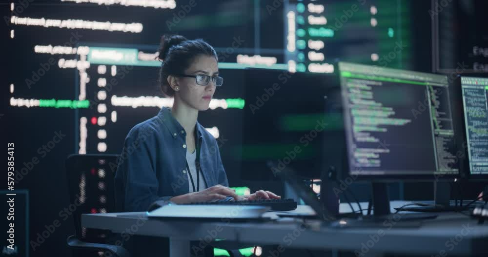 Fototapete Female Programmer Working in Monitoring Control Room, Surrounded by Big Screens Displaying Lines of Programming Language Code. Portrait of Woman Creating a Software. Abstract Futuristic Coding Concept