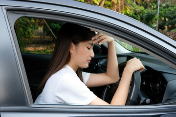 Obraz na płótnie Canvas Stressed woman driver sitting inside her car