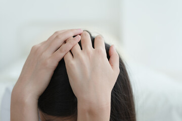 depressed woman holding head in hands 