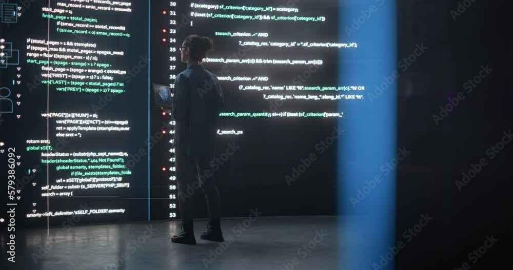 Aufkleber Portrait of Young Woman Working on Laptop Computer, Looking at Big Digital Screen Displaying Back-end Code Lines. Professional Programmer Developing a Big Data Interface Software Project