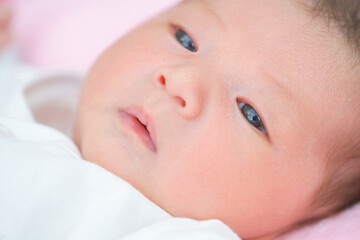 Portrait of a newborn Asian baby girl sleep on the bed , cute Fat baby 5 day.