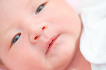 Portrait of a newborn Asian baby girl sleep on the bed , cute Fat baby 5 day,close up.