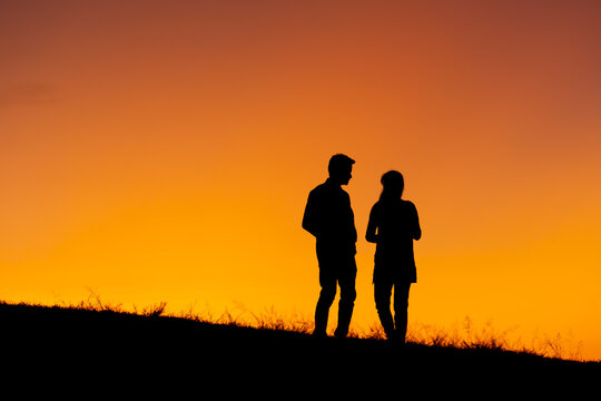 Silhouette of a couple in love at sunset background. Hadubai view point Ban Lao Wu, Wiang Haeng, Chiang Mai Copy space for use. Silhouette of lover on hill in sunset