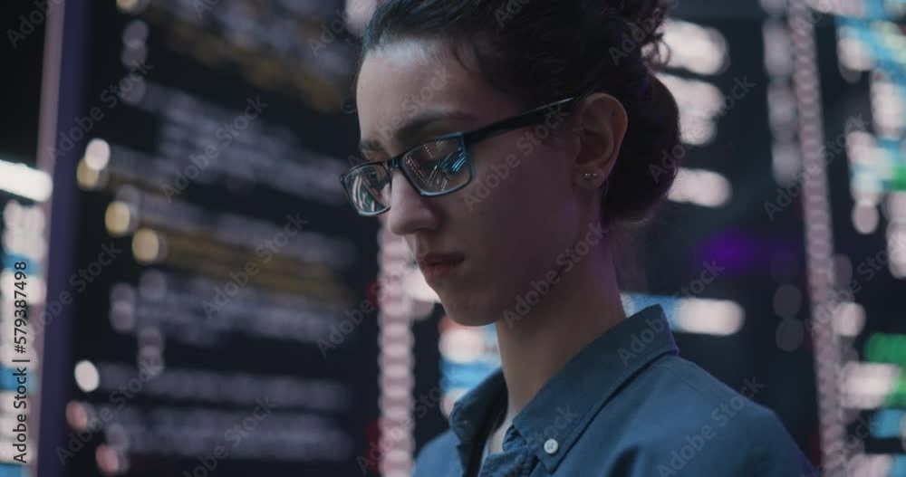 Leinwandbilder Close Up Portrait of Woman Working on Computer, Lines of Code Language Reflecting on her Glasses from Big Display Screens. Female Programmer Developing New Software, Coding, Managing Cybersecurity