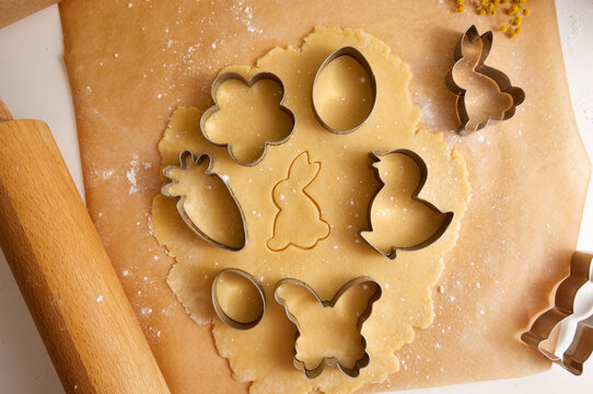 Easter Cookie Dough And Cookie Cutters On Baking Paper Close-up