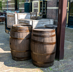 some wooden wine barrels outside in the sun