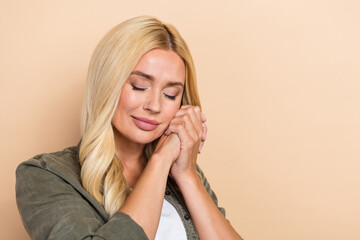 Fototapeta premium Photo of gentle pretty lovely lady wear khaki cozy clothes two arms touch cheeks near empty space isolated on beige color background