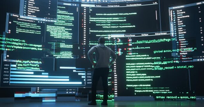 Back View of Young Black Man Walking and Looking at Big Digital Screens Glitching While Displaying Code Lines. Professional Hacker Breaking Through Cybersecurity Protection System, Changing Code