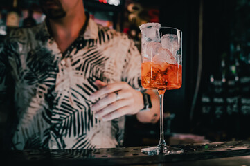 man hand bartender making cocktail in glass on the bar counter