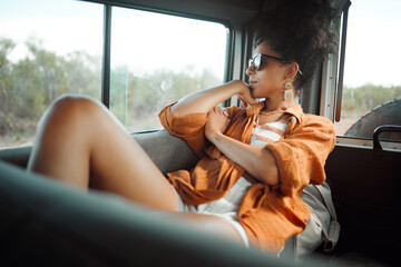 Road trip, countryside and travel woman in van thinking about holiday adventure, journey or nature love. Calm and relax passenger girl with sunglasses at caravan window for natural drive or transport