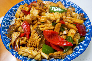 A delicious Chinese home-cooked dish, stir-fried fresh squid with vegetable pepper