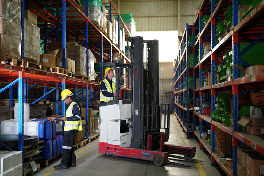 Warehouse workers checking the inventory. Products on inventory shelves storage. .Worker Doing Inventory in Warehouse. Dispatcher in uniform making inventory in storehouse. supply chain concept