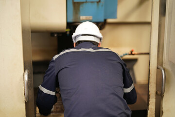 Industrial factory employee working in metal manufacturing industry