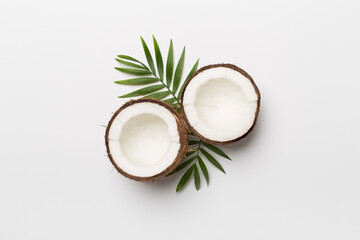 Coconut with leaves on white background, top view