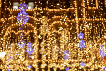 Golden sparkling lights. Blurred abstract background. Blurred festive city lights