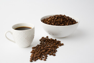 Coffee cup with roasted beans on white background. Top view with copy space
