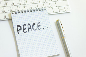 the word peace is written in a notebook