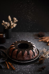 Dark chocolate bundt cake decorated with chocolate ganache glaze and nuts. Marble chocolate bundt...