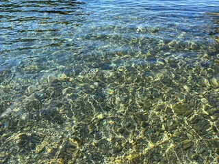 Sea pebbles beach with crystal clear water.