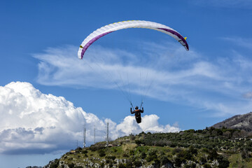 Paragliding concept, paraglider pilot fly in sky on beauty nature mountain landscape Norma Italy...