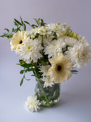 bouquet of white flowers in a vase, close-up photo on a white background, chrysanthemums, gerberas, gypsophila,  