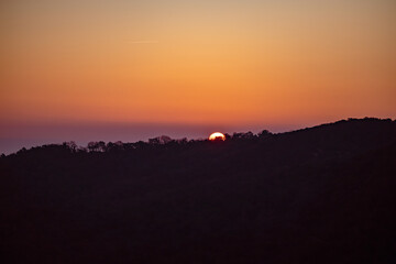 Sunrise over forest in village of Gassin, France