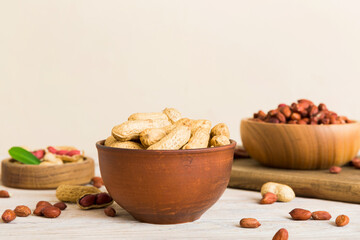 Fresh healthy peanuts in bowl on colored table background. Top view Healthy eating bertholletia concept. Super foods