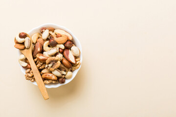 mixed nuts in bowl. Mix of various nuts on colored background. pistachios, cashews, walnuts, hazelnuts, peanuts and brazil nuts