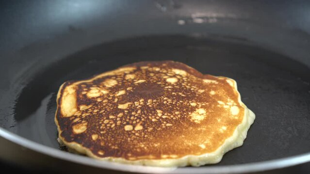 pouring honey over some egg pancakes
