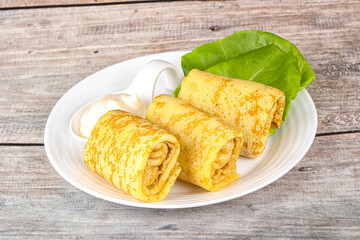 Stuffed pancakes with cream sauce