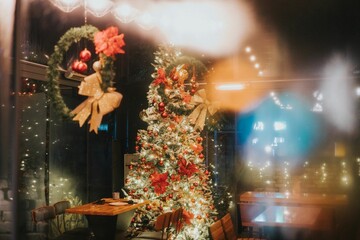 Colorful Christmas tree in a beautifully decorated empty cafe