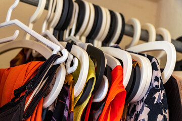 Colorful women clothes and dresses on hangers in closet Mexico.