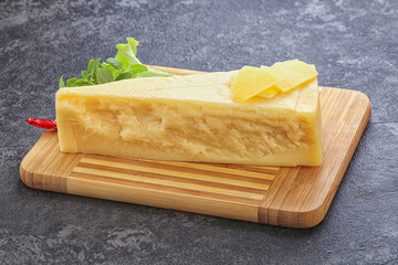 Parmesan cheese piece over board