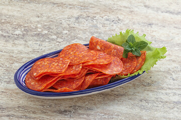 Sliced pepperoni sausage in the bowl