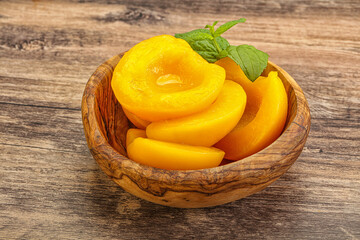 Sweet ripe canned peaches with mint
