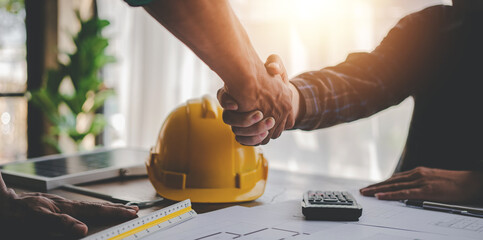 engineering team shaking hands start planning for architecture Engineer sketching construction project concept with architect equipment Consult about their construction project.