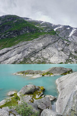 Green River, going through mountains covered by green grass and snow