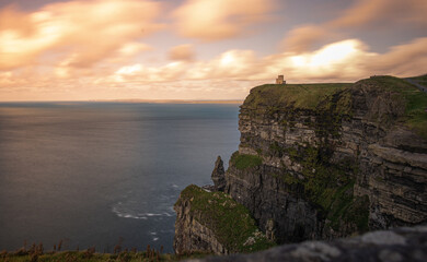 Stone Cliffs in Ireland on a cloudy day with a beautiful sunset by the ocean in spring