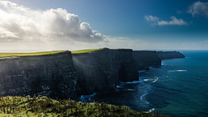 Stone Cliffs in Ireland on a cloudy day with a beautiful sunset by the ocean in spring