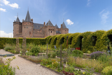 Fototapeta na wymiar Medieval Dutch castle - Muiderslot, with the herb garden in the foreground.