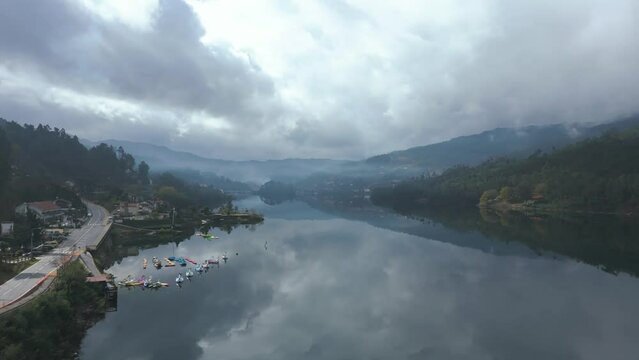 Aerial shot of the reflection of the cloudy sky in the calm water of a river in the north of Portugal, next to Peneda Geres