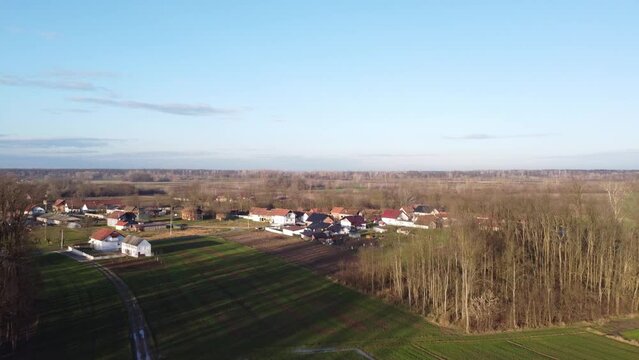 Aerial view of village surrounded by houses and trees