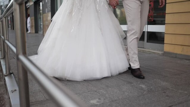 Beautiful view of a bride and groom feet walking in the street