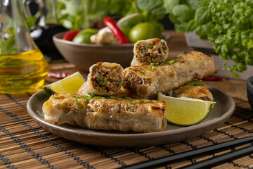 Portion of spring rolls stuffed with meat. Served with sauce.