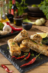 Portion of spring rolls stuffed with meat. Served with sauce.