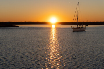 Sunset on the St. Marys River, border between Georgia and Florida near Atlantic Ocean. Sailboats at anchor. 