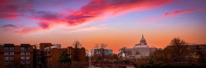 Providence in Rhode Island Skyline Cityscape at Twilight. Entering Providence at dawn. Road Trip into Dramatic Blazing Sunrise over Highway Bridge with view of Rhode Island State House