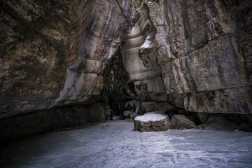inside view of frozen river of maligne canyon in jasper national park with curved shpaes of rocks