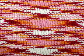 Abstract knitted texture from red, pink and white flowers.
 